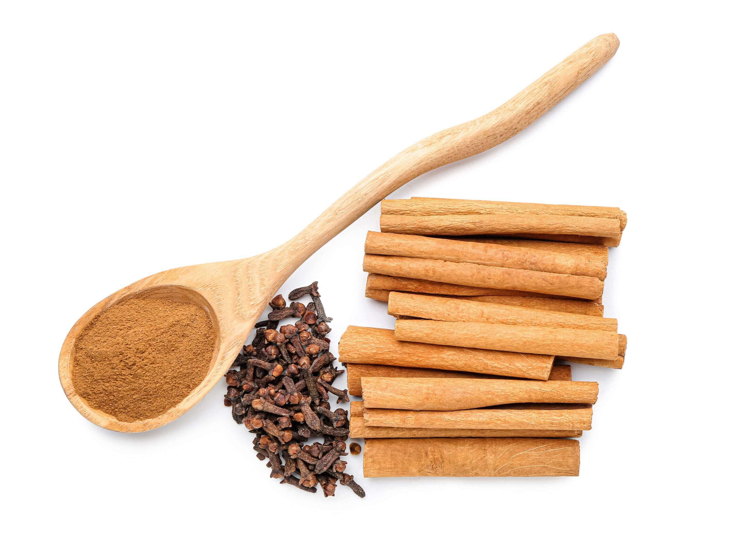 Cinnamon sticks with ground cinnamon and cloves on a white background.
